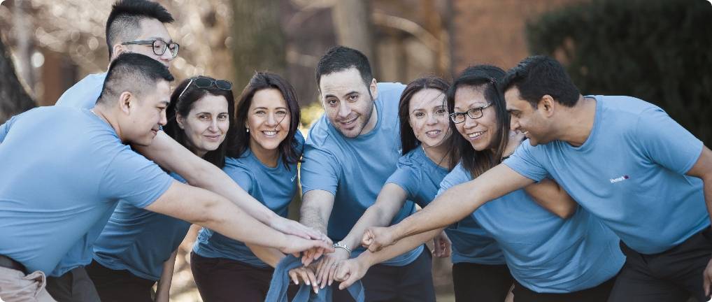 Team groupshot of the team with the hands in a pile